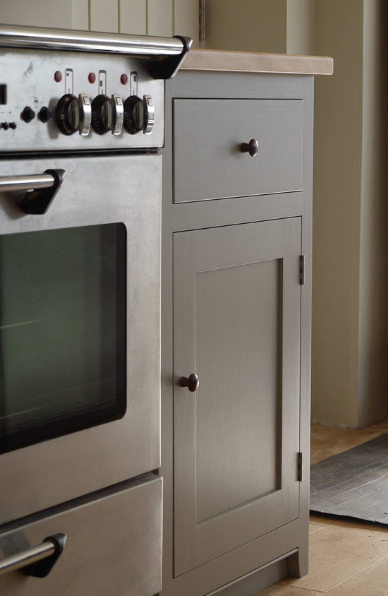 Shaker style kitchen. Birch plywood cabinets with hand painted hardwood frames (Farrow and Ball, Lamp Room Gray). Sink area with integral dishwasher, traditional ceramic inset sink and full stave beech top and upstand. Dovetailed drawers made of solid beech with painted hardwood fronts and walnut hand turned knobs.