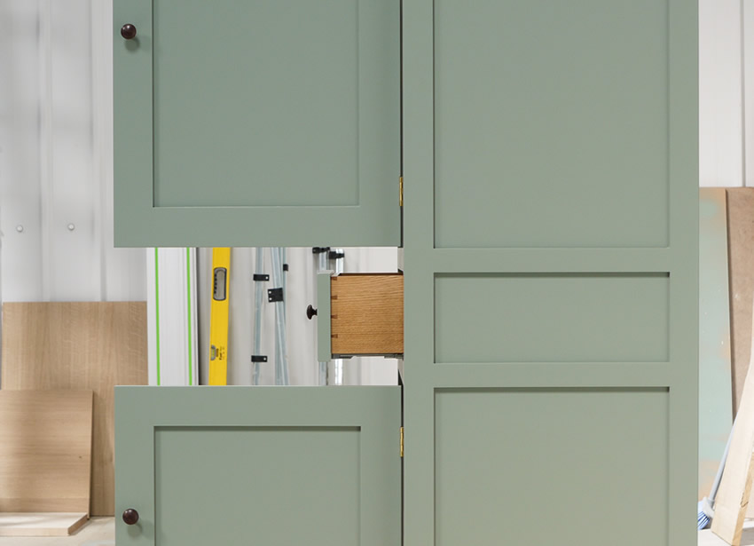 Small larder cupboard handpainted in Farrow and Ball Estate Eggshell - Castle Gray. Solid maple carcass construction with birch ply panels and shelves. Oak dovetailed drawers and oak cornice.