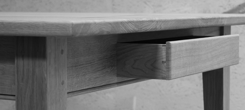 Oak Shaker style table with tapered legs and oak dovetailed drawer. The table is finished with hardwearing 'Osmo' hardwax oil.